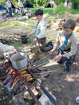 Pfadfinder kochen über der Feuerstelle